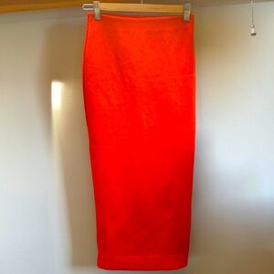 Bright red/orange tight skirt. Very hot 🔥